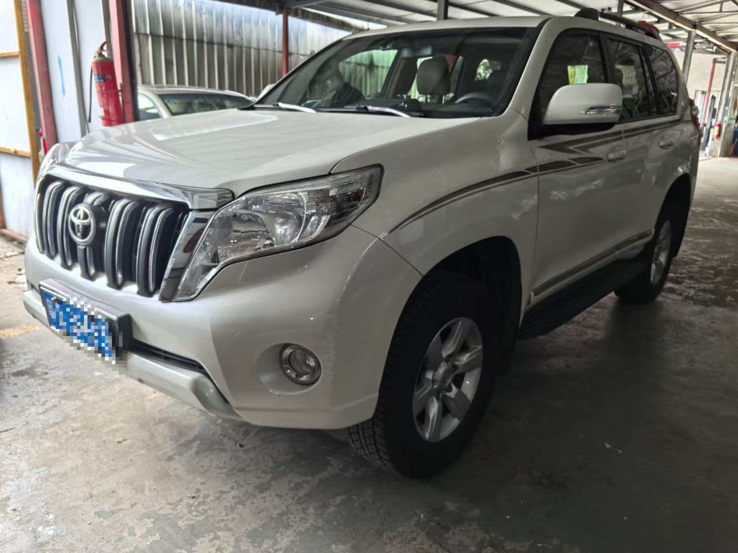 White Toyota Prado shown as a user-provided large SUV reference